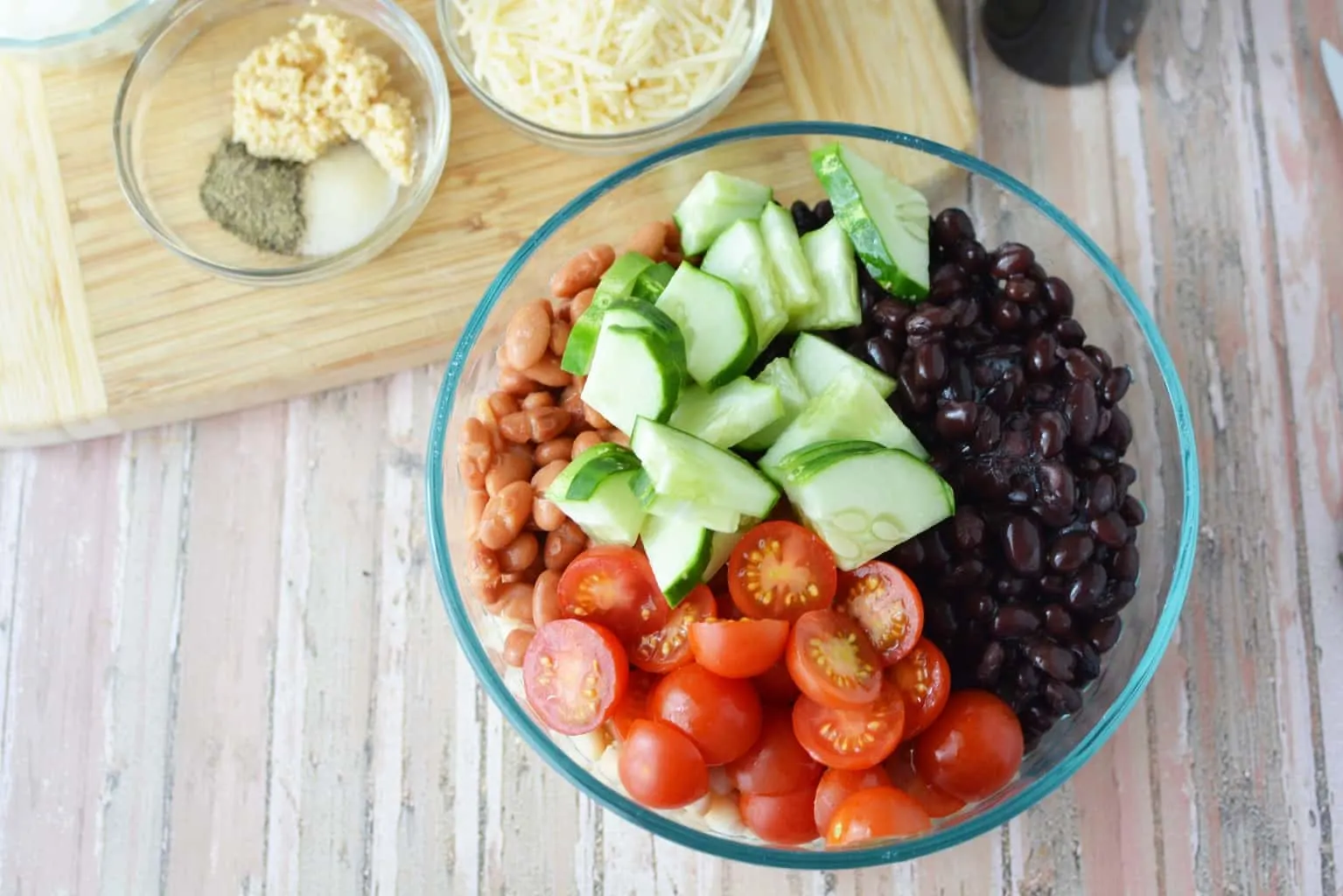 Are you planning a game day or super bowl party? This Easy Cold Bean Salad has the taste of 'mush' beans along with the crunch of an onion and a cucumber.  It also has a balsamic-y taste because of the vinegar, but it's not too strong.