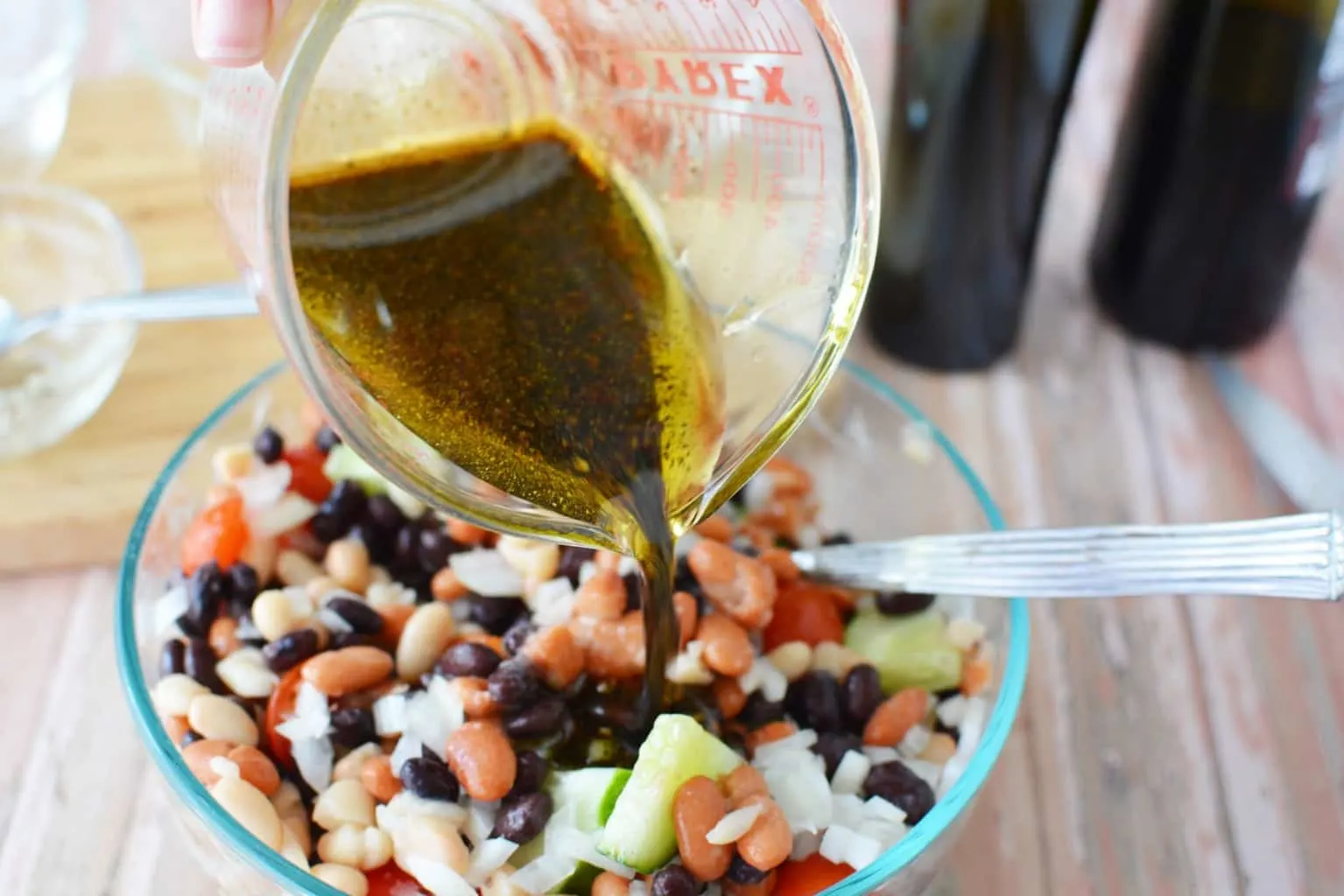 Are you planning a game day or super bowl party? This Easy Cold Bean Salad has the taste of 'mush' beans along with the crunch of an onion and a cucumber.  It also has a balsamic-y taste because of the vinegar, but it's not too strong.