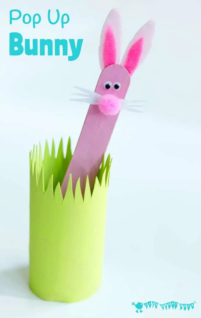 pink popsicle stick bunny craft in green grass