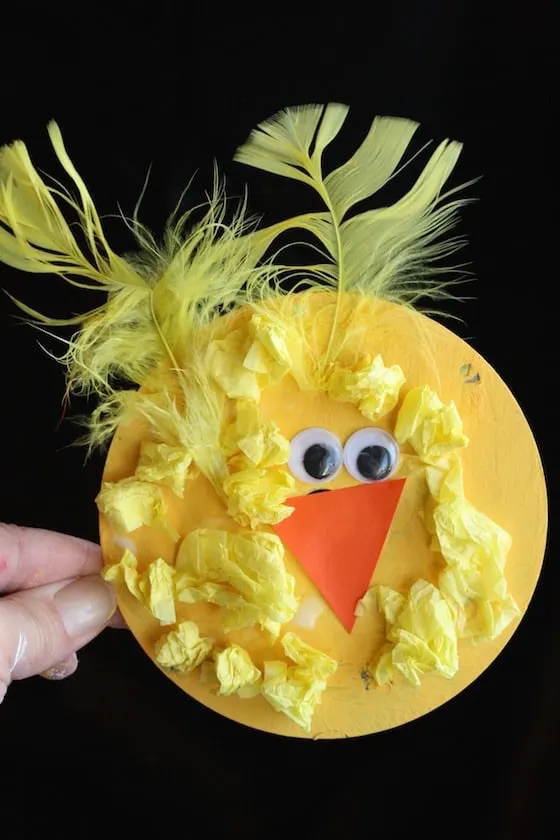 baby chick craft made with tissue paper, feathers and a cd