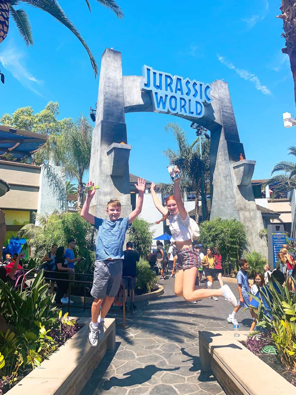 a boy and girl jumping at Jurassic World The Ride Universal Studios Hollywood