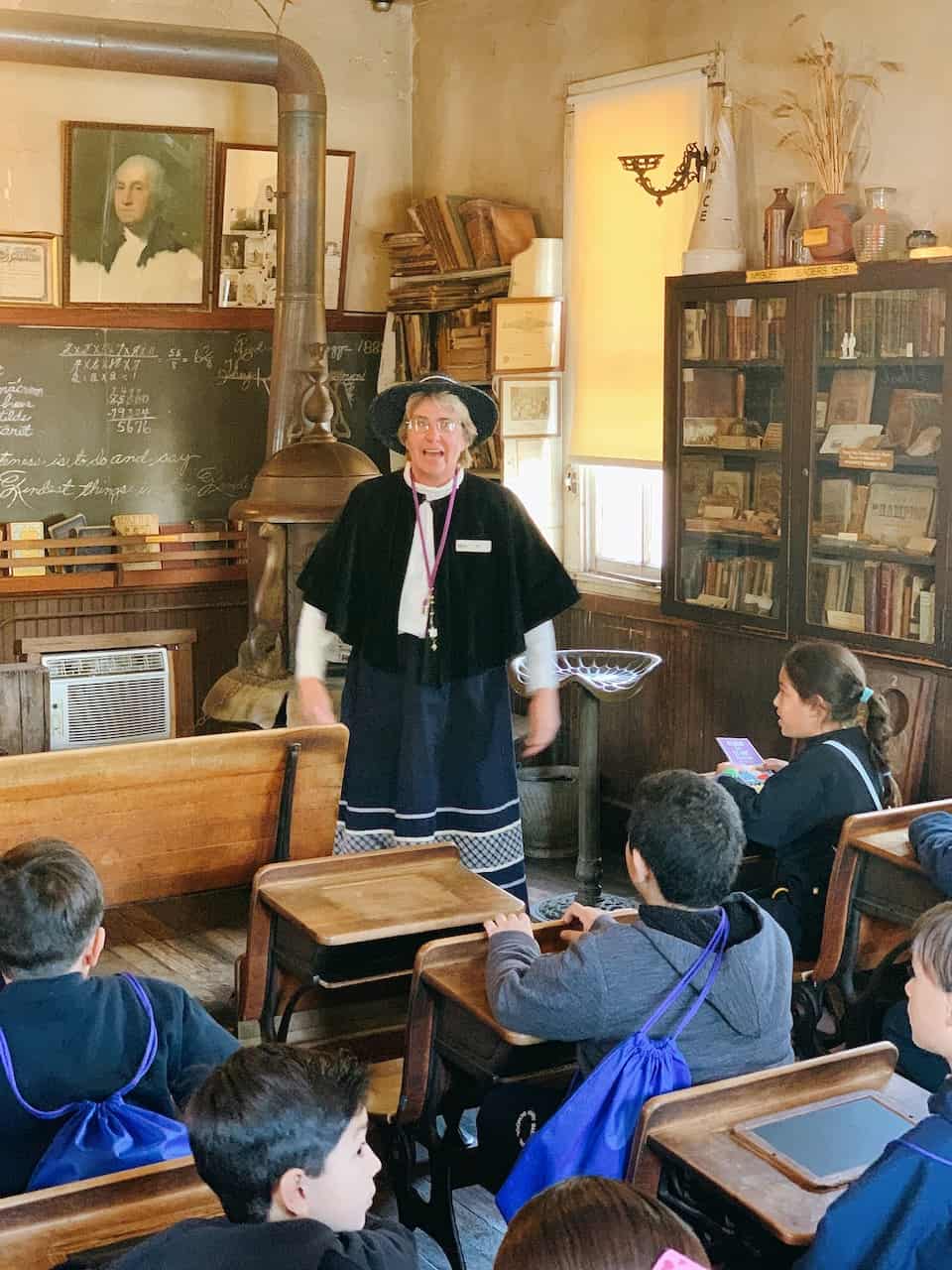 Lady explaining California history in a one room school house in Buena Park