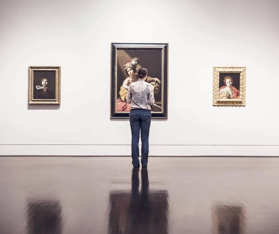 Woman standing in front of art at an art museum